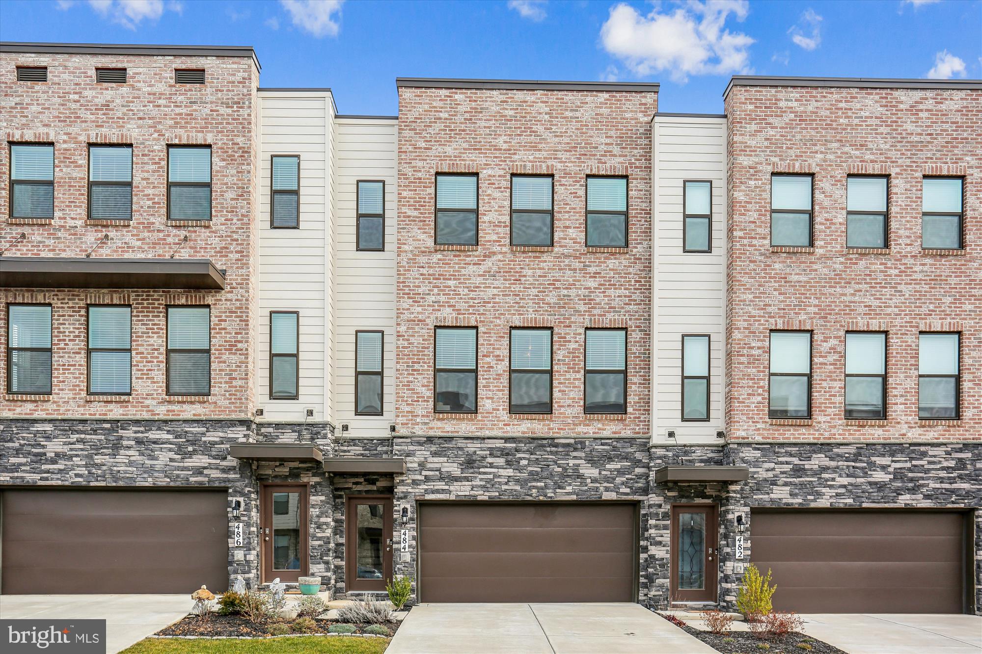 a front view of a brick building with a lot of windows