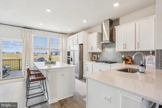 a kitchen with white cabinets and appliances