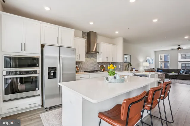 a kitchen with a refrigerator a stove a microwave and island