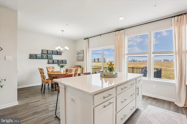 a kitchen with a stove a refrigerator and a dining table