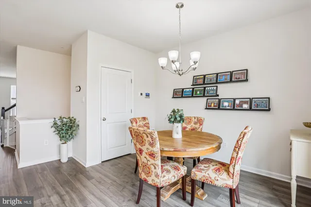 a view of a dining room with furniture wooden floor and a chandelier