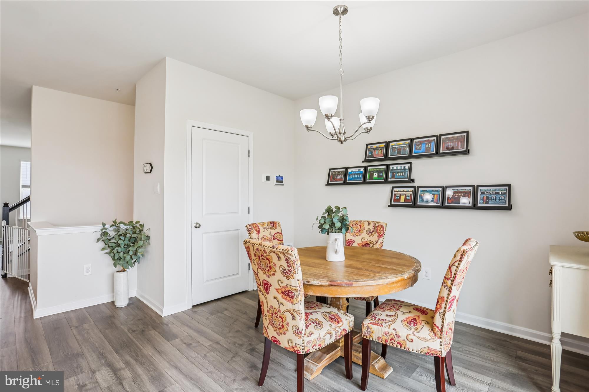 484 Tiller Street Frederick, MD 21701 - Photo 15 of 44 a view of a dining room with furniture wooden floor and a chandelier