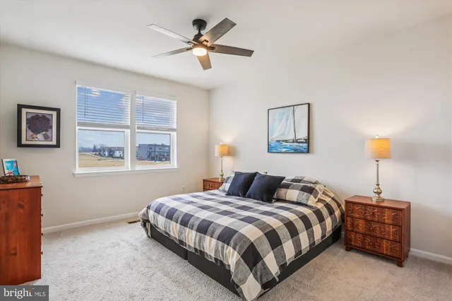 a bedroom with a bed a lamp and a window