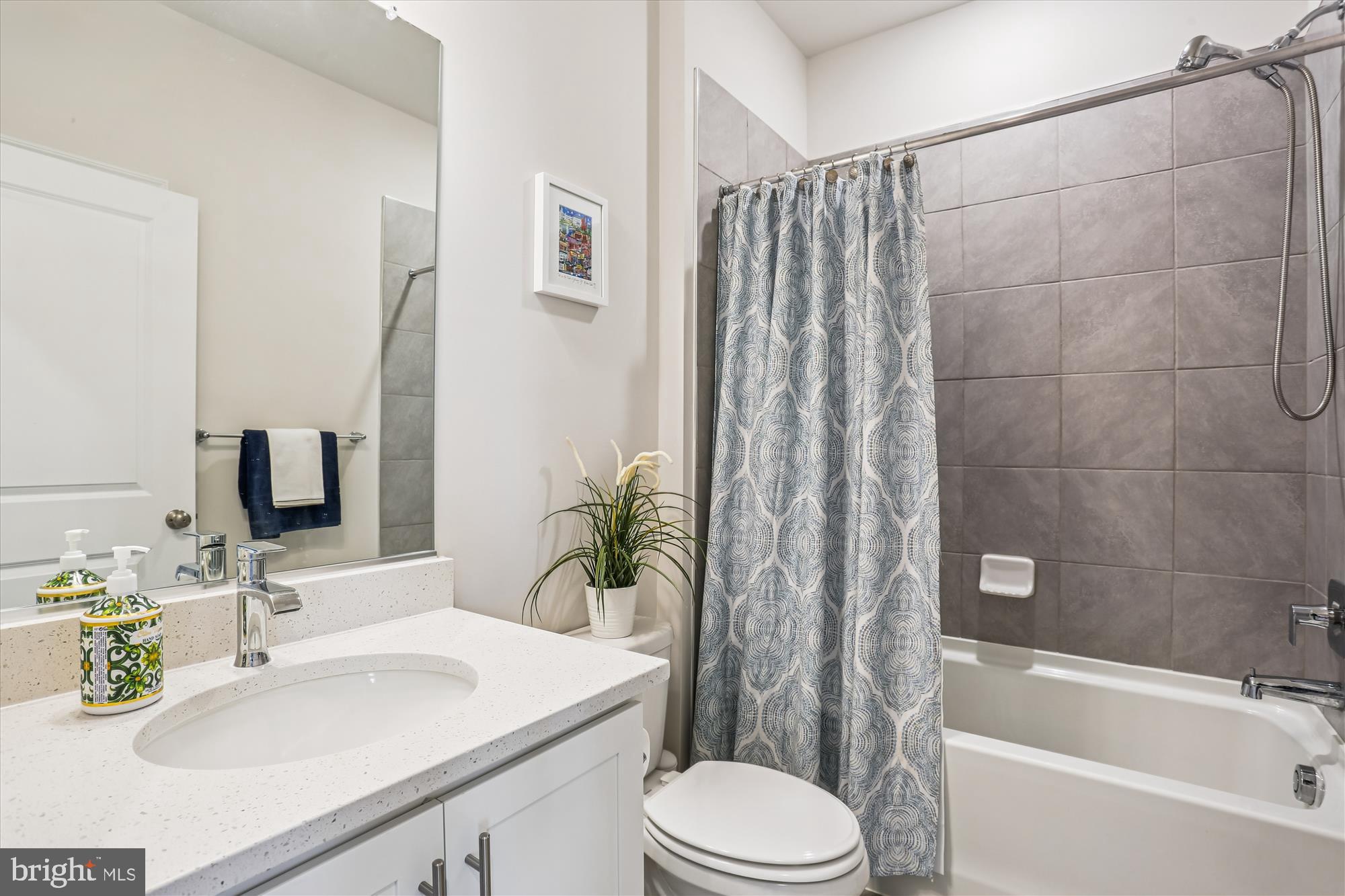 484 Tiller Street Frederick, MD 21701 - Photo 26 of 44 a bathroom with a sink toilet a mirror and shower