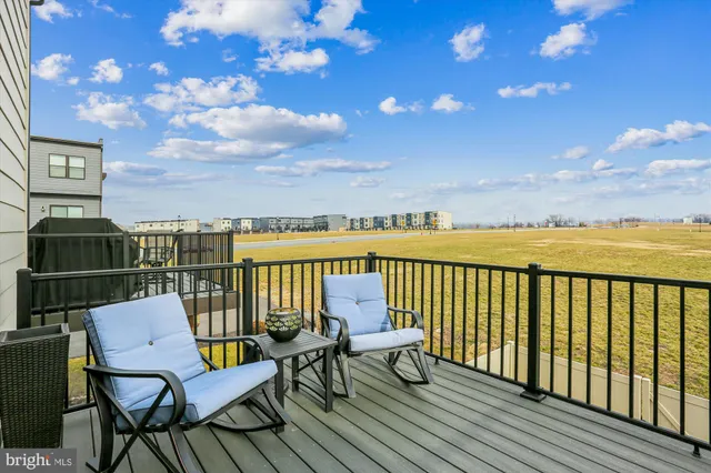 a balcony with wooden floor and city view