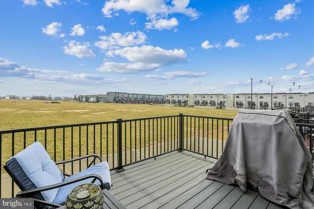 a balcony with wooden floor and city view