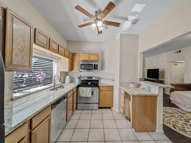 a kitchen with a stove sink and microwave