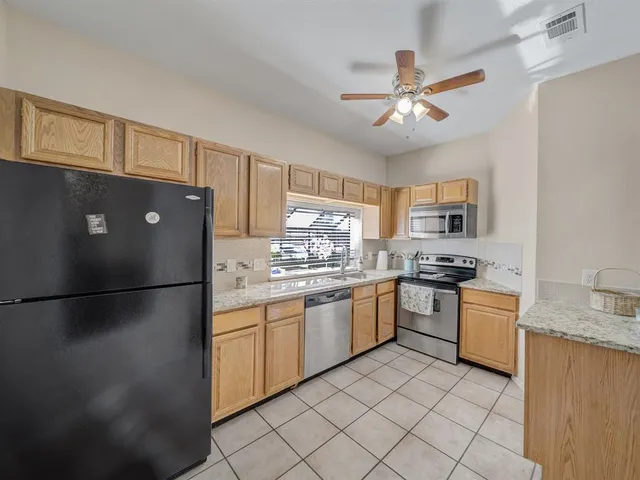 a kitchen with a refrigerator and a sink