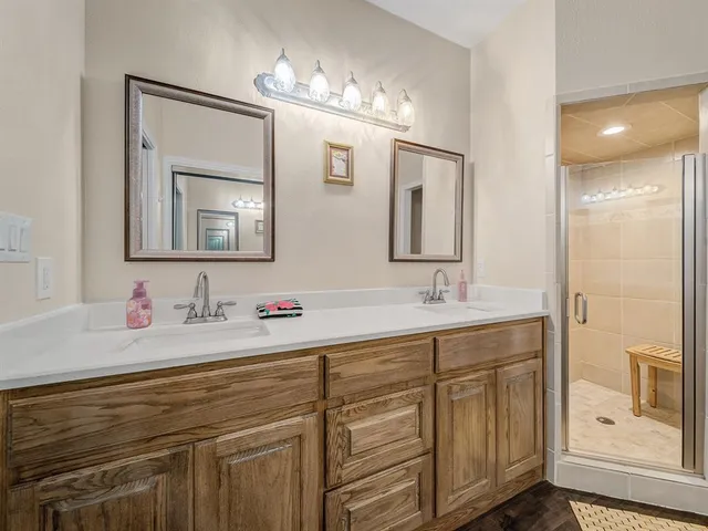 a bathroom with a double vanity sink and mirror