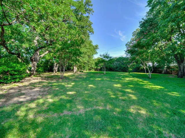 a backyard of a house with lots of green space