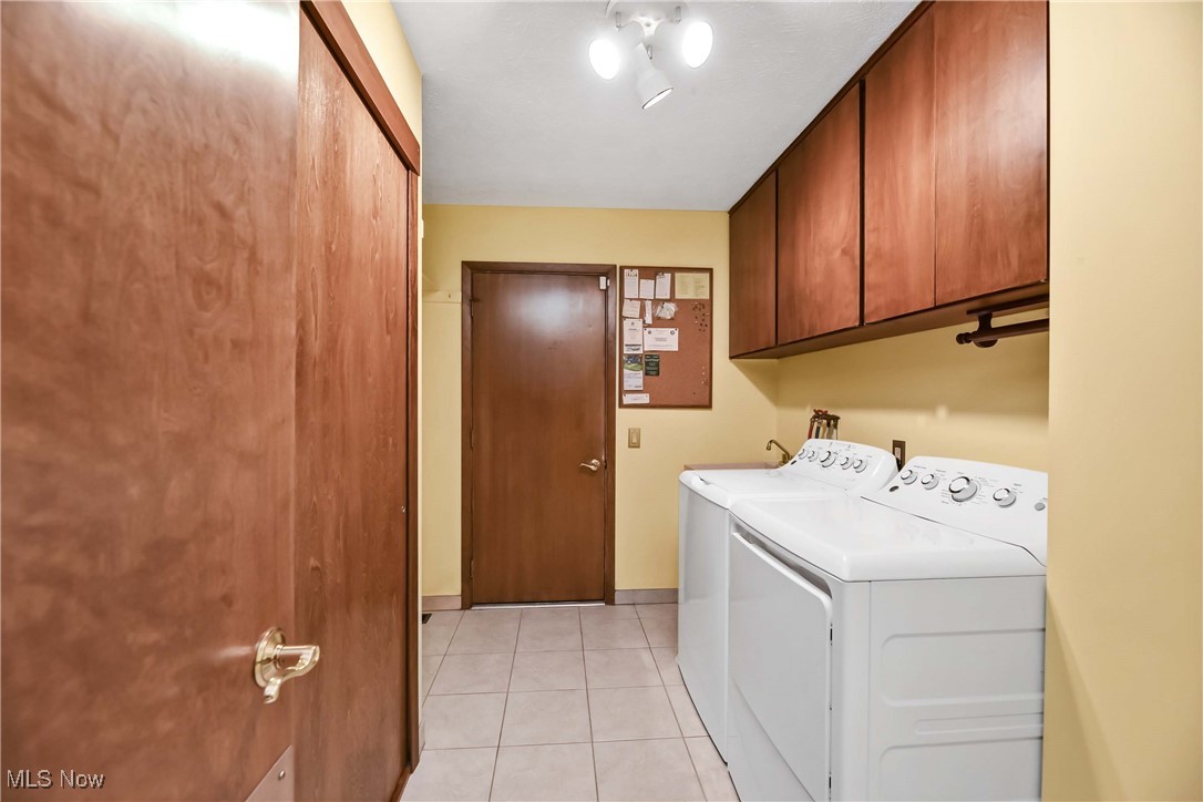 5076 North Barton Road North Ridgeville, OH 44039 - Photo 21 of 41 Clothes washing area with light tile patterned floors, cabinets, and washer and clothes dryer