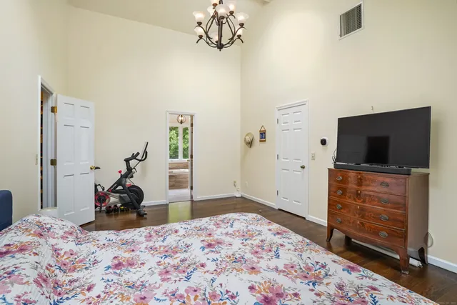 a bedroom with a bed and flat screen tv