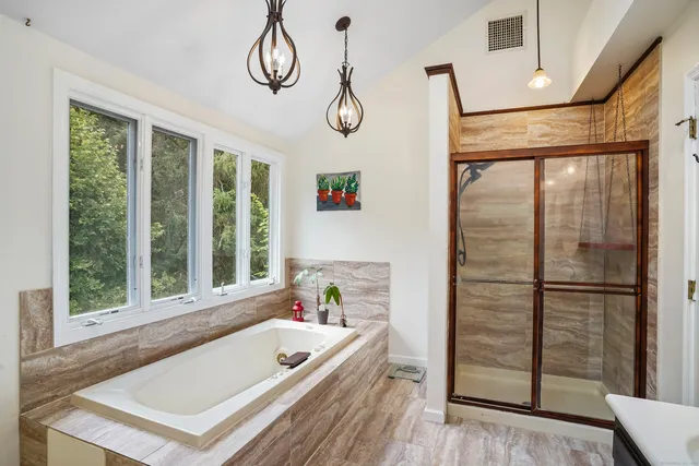 a view of dining room with wooden floor and large window