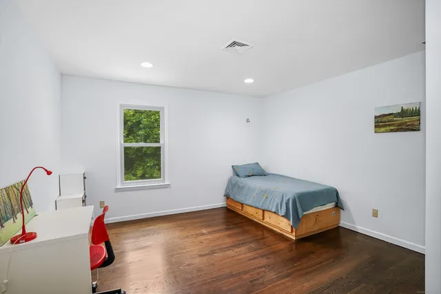a living room with a bed furniture and a window