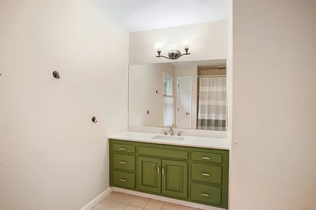 a bathroom with a sink vanity and mirror