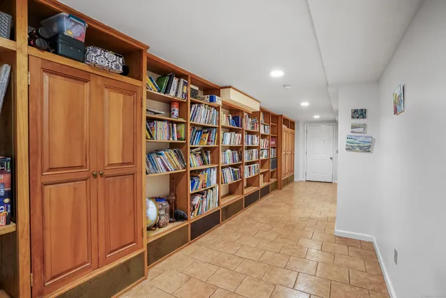 a view of a hallway with wooden shelves
