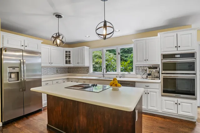 a kitchen with a sink a stove a microwave and cabinets