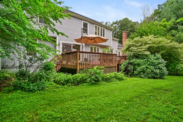 a front view of a house with a yard and plants