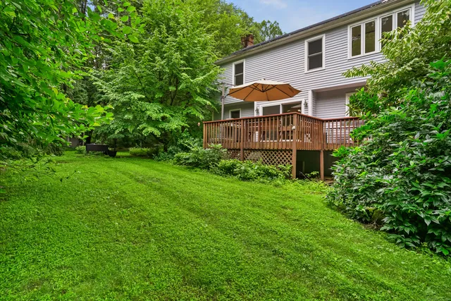 a view of a house with a backyard