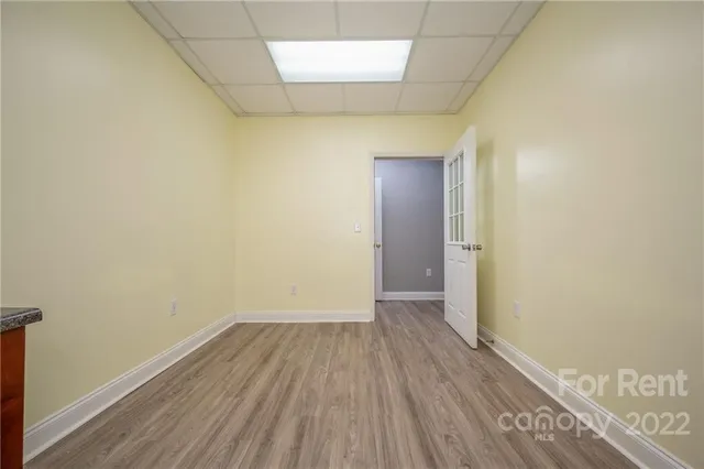 a view of a room with wooden floor