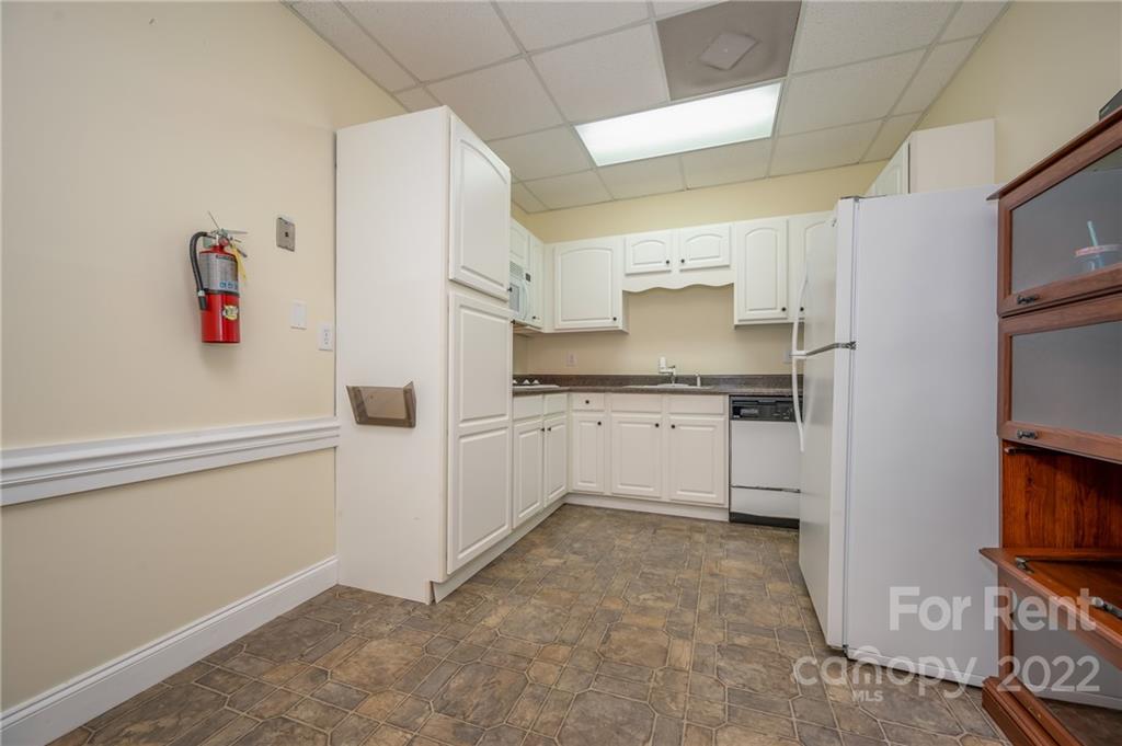 406 Daniel Road Spindale, NC 28160 - Photo 20 of 33 a kitchen with white cabinets and white appliances