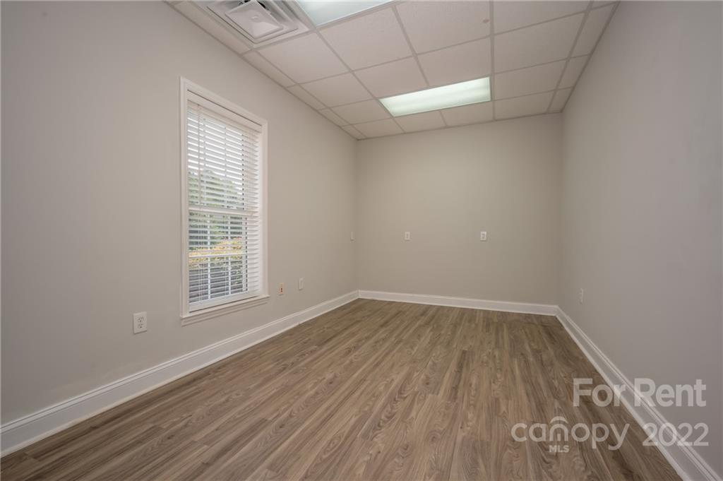 406 Daniel Road Spindale, NC 28160 - Photo 25 of 33 an empty room with wooden floor and windows