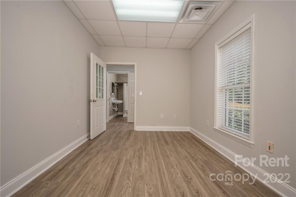 406 Daniel Road Spindale, NC 28160 - Photo 26 of 33 a view of an empty room with wooden floor and a window