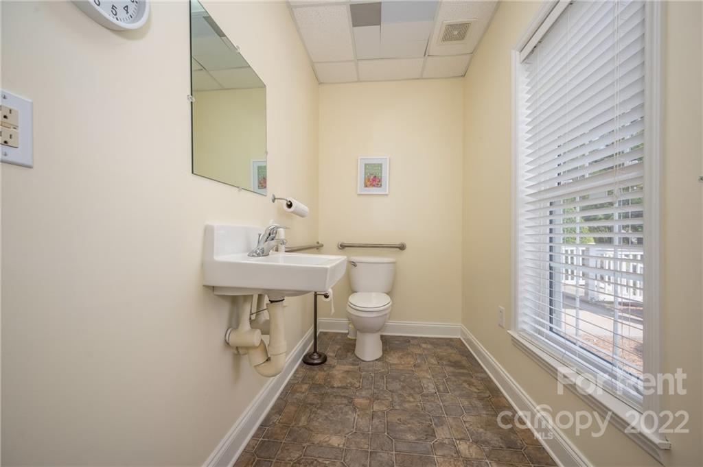 406 Daniel Road Spindale, NC 28160 - Photo 27 of 33 a bathroom with a sink a toilet and mirror