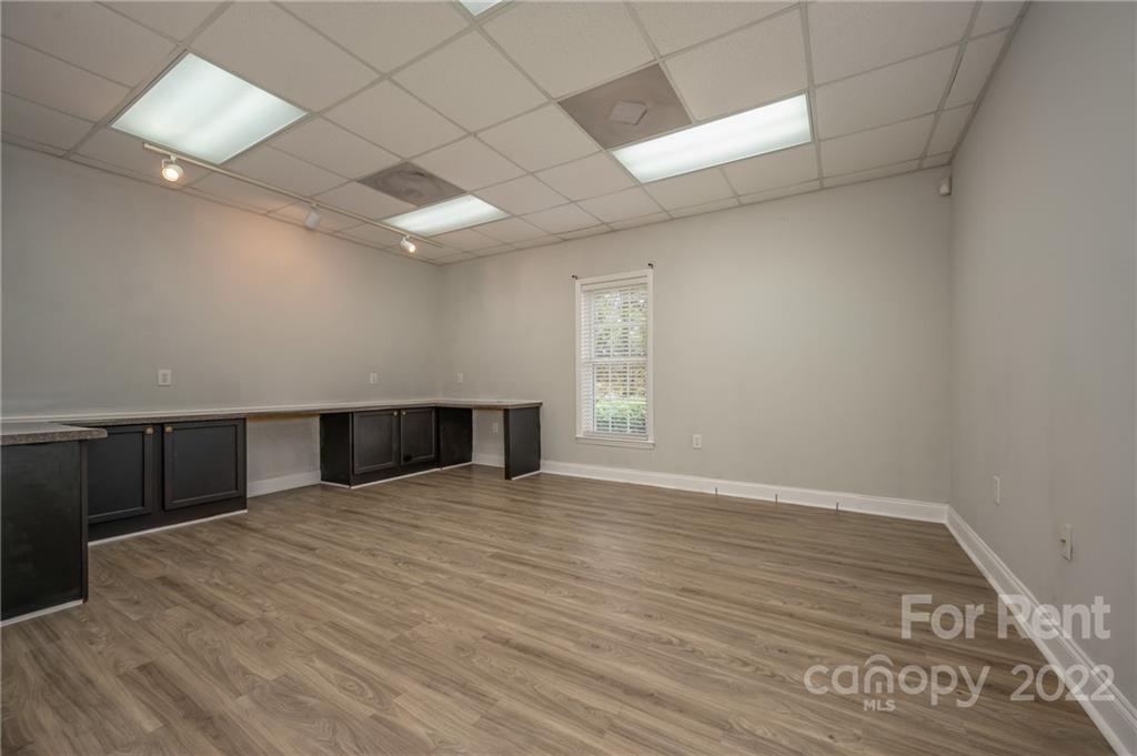 406 Daniel Road Spindale, NC 28160 - Photo 28 of 33 an empty room with wooden floor and windows