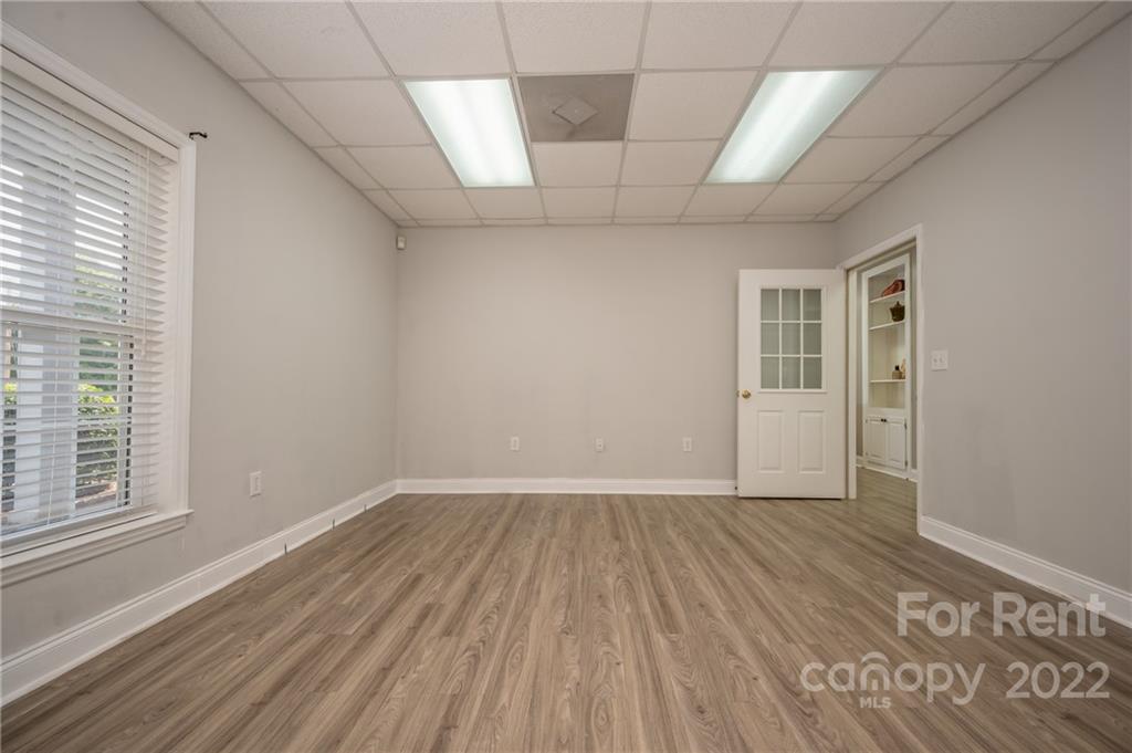 406 Daniel Road Spindale, NC 28160 - Photo 29 of 33 an empty room with wooden floor and windows