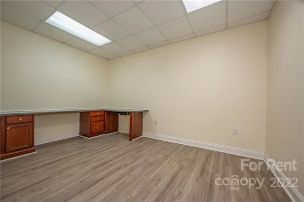 a room with wooden floor and cabinets