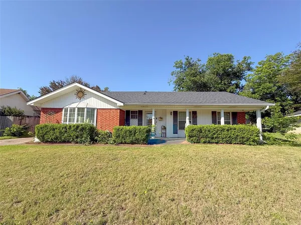 a front view of a house with yard and green space
