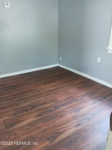 a view of a room with wooden floor