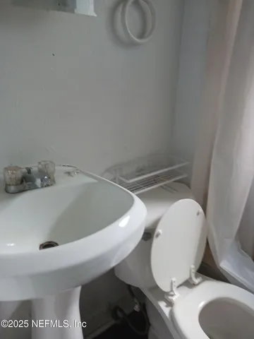 a bathroom with a sink and toilet