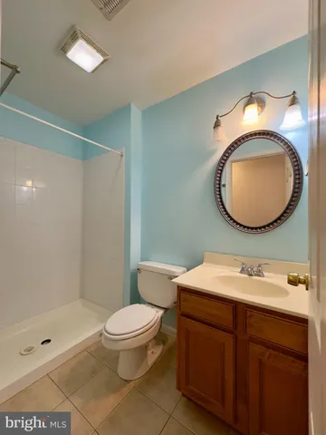 a bathroom with a toilet a sink and a mirror