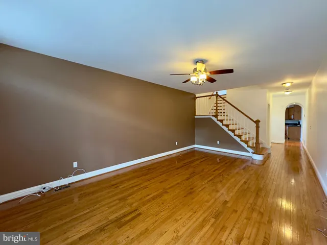 a view of a room with wooden floor and a chandelier