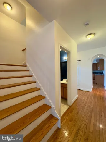 a view of entryway and hall with wooden floor