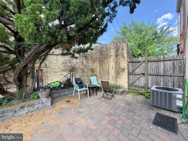 a view of an outdoor sitting area with wooden fence