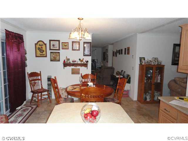 17206 Hamilton Arms Road Dewitt, VA 23840 - Photo 4 of 12 a living room with furniture and a chandelier