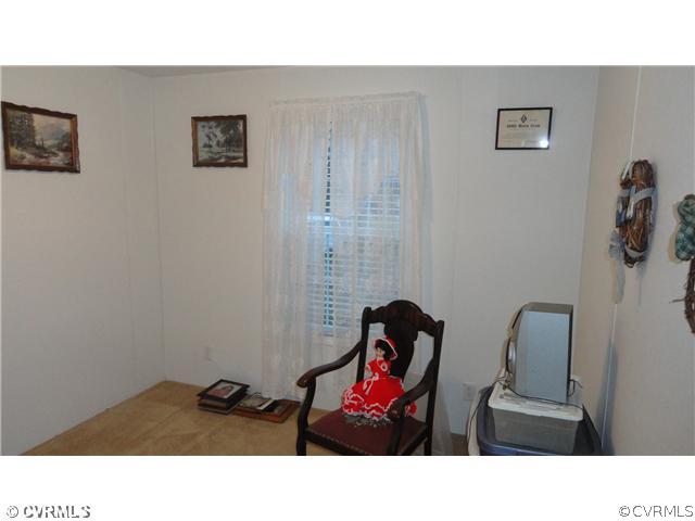 17206 Hamilton Arms Road Dewitt, VA 23840 - Photo 8 of 12 a room with furniture and a couch
