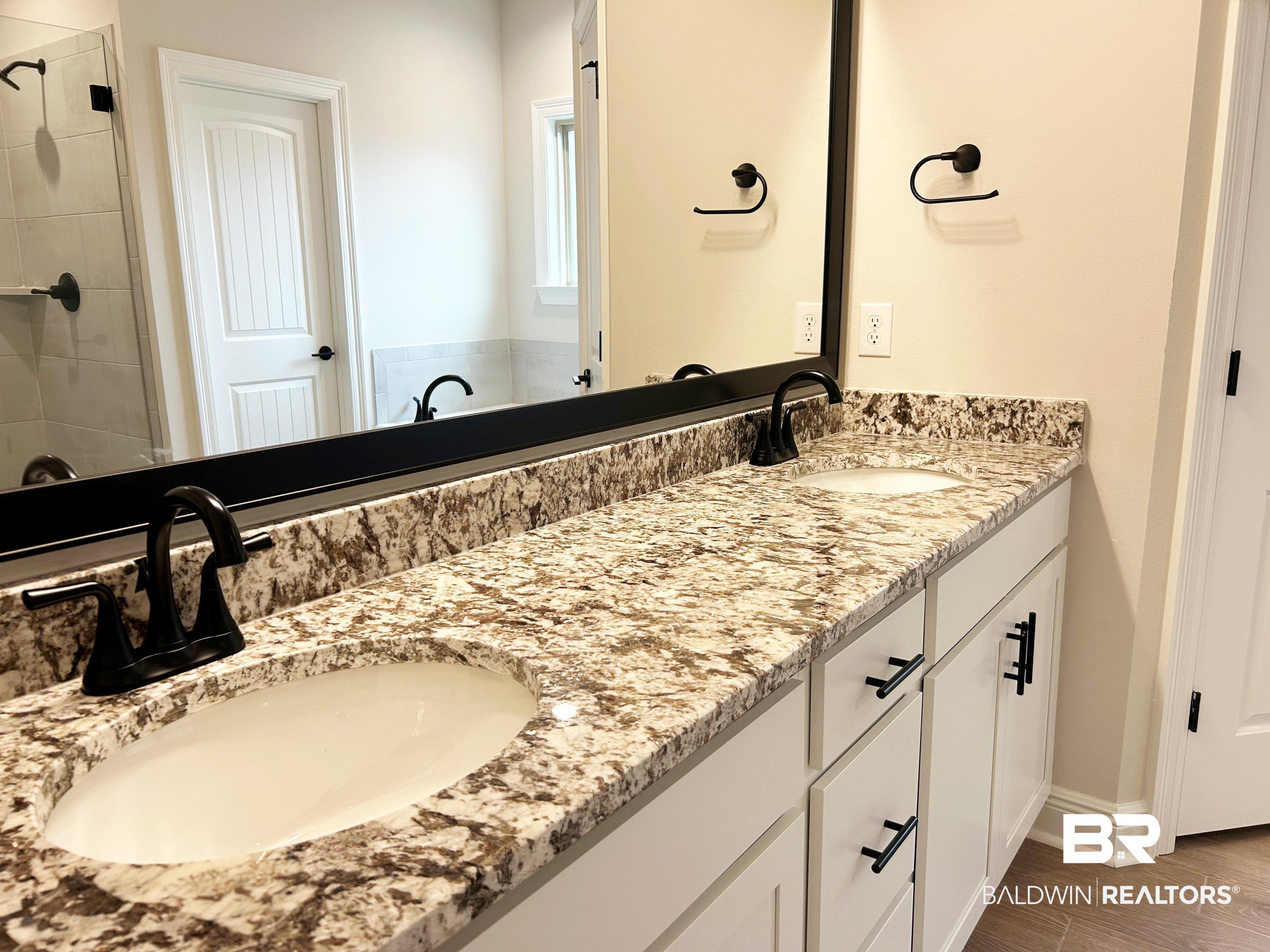 873 Sumter Loop Foley, AL 36535 - Photo 21 of 26 Bathroom featuring double vanity, tiled shower, and wood tiled floors