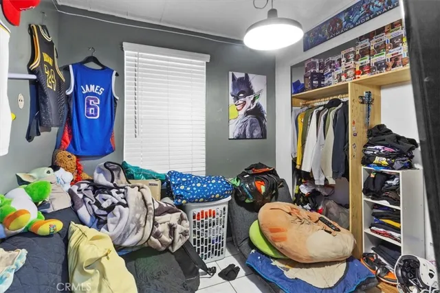 a living room with lots of furniture and clothes