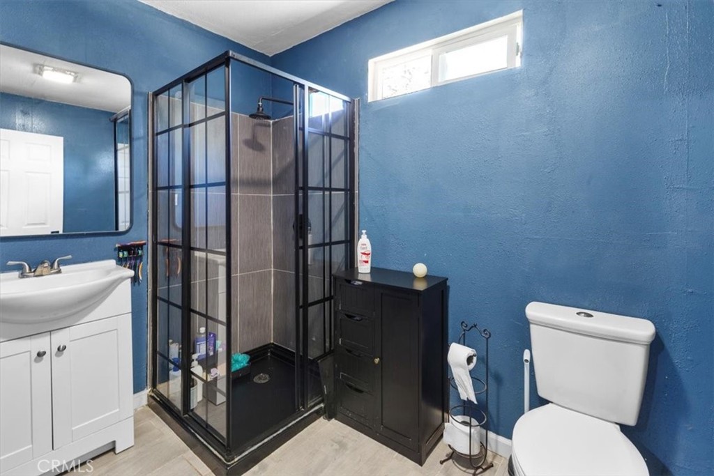 3715 South Neece Street Corona, CA 92879 - Photo 13 of 20 a bathroom with a toilet a sink and shower