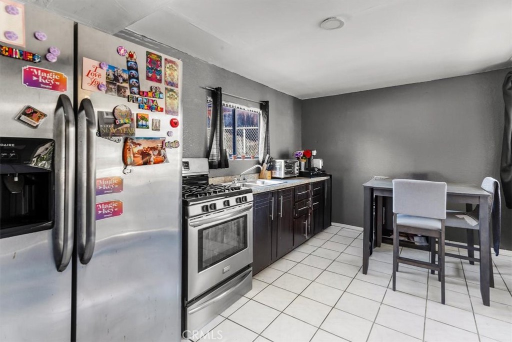 3715 South Neece Street Corona, CA 92879 - Photo 15 of 20 a kitchen with stainless steel appliances granite countertop a refrigerator and a stove