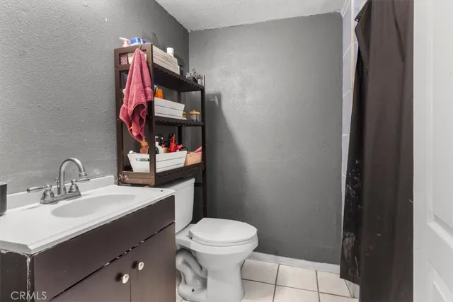 a bathroom with a sink vanity mirror and toilet