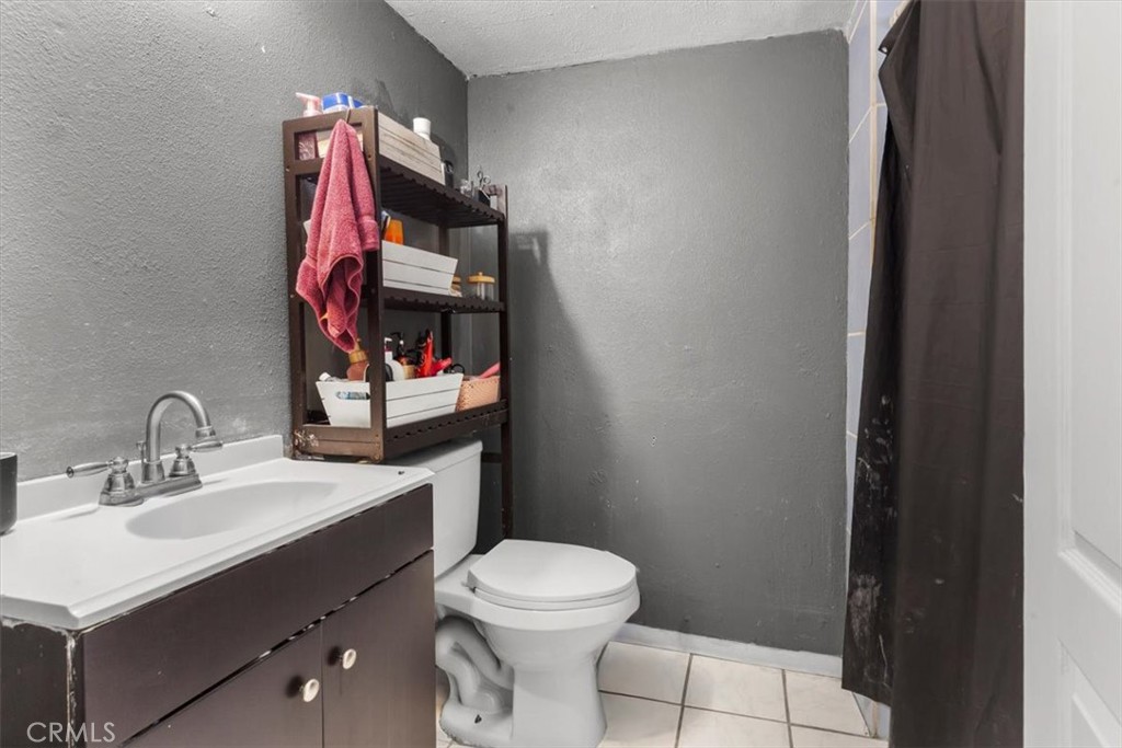 3715 South Neece Street Corona, CA 92879 - Photo 18 of 20 a bathroom with a sink vanity mirror and toilet