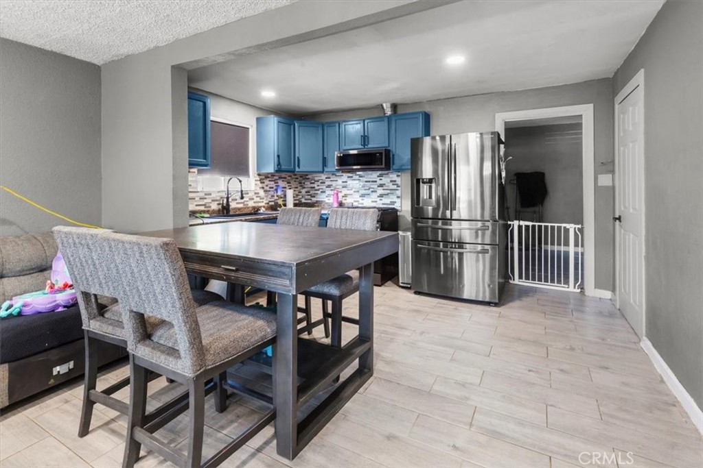3715 South Neece Street Corona, CA 92879 - Photo 7 of 20 a kitchen with refrigerator and chairs