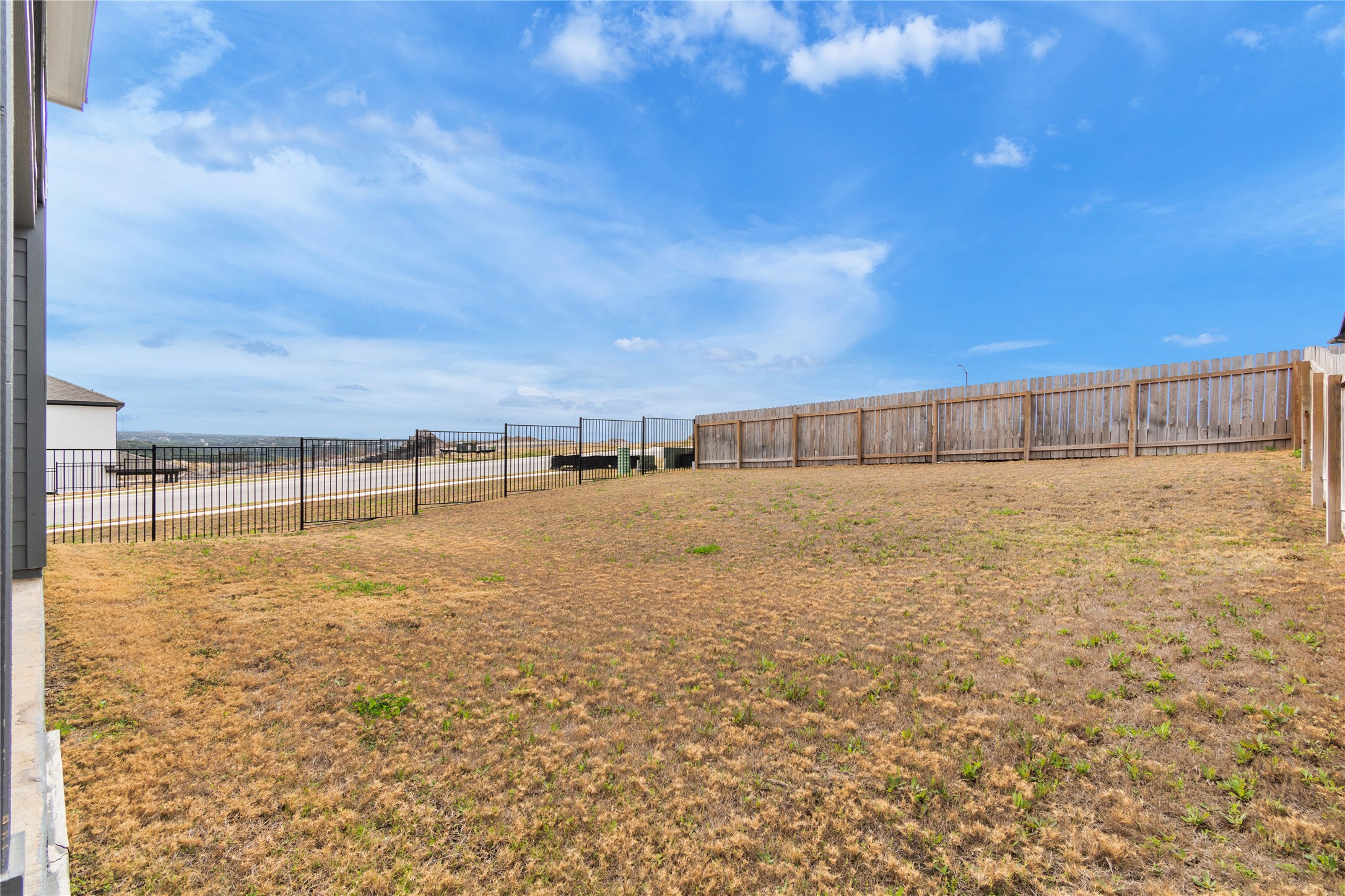 8500 Red Bottle Brush Road Lago Vista, TX 78645 - Photo 33 of 33 A spacious backyard awaits, featuring a privacy fence and scenic distant views.