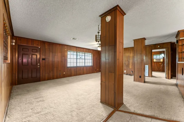 an empty room with windows and closet