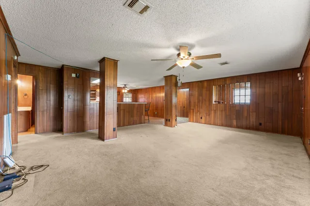 a view of an empty room with a ceiling fan